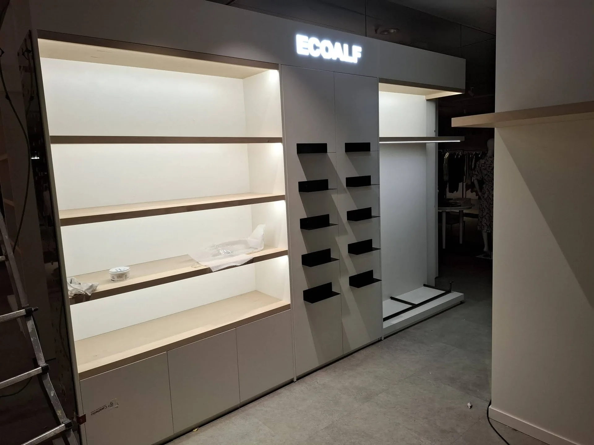 Ecoalf Marbella womenswear illuminated display module during installation