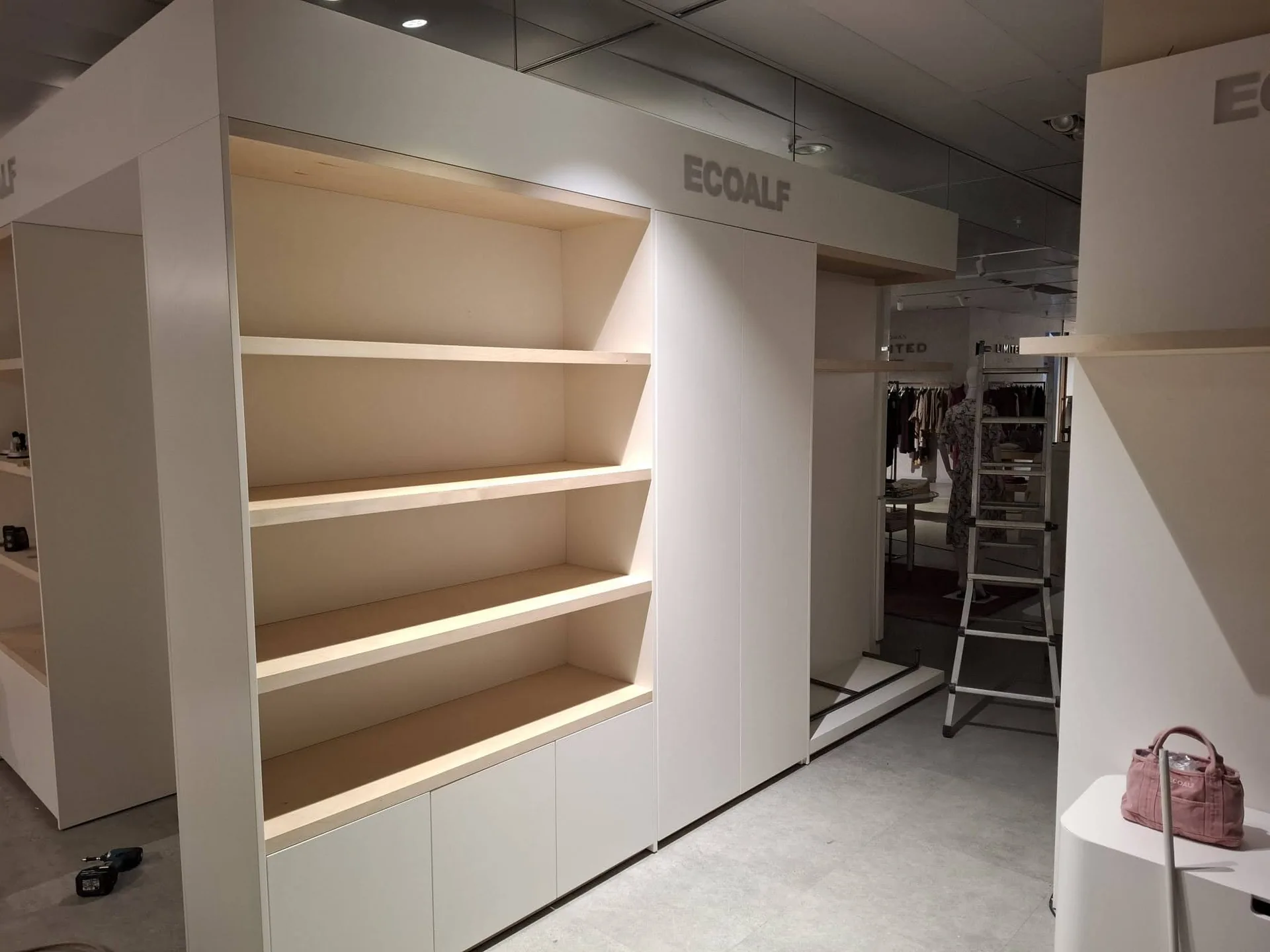 Ecoalf Marbella womenswear illuminated shelving during installation
